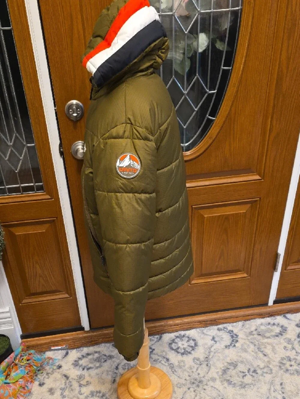 Levi's Olive Green Kids Puffer Jacket with Red and White Hood Trim